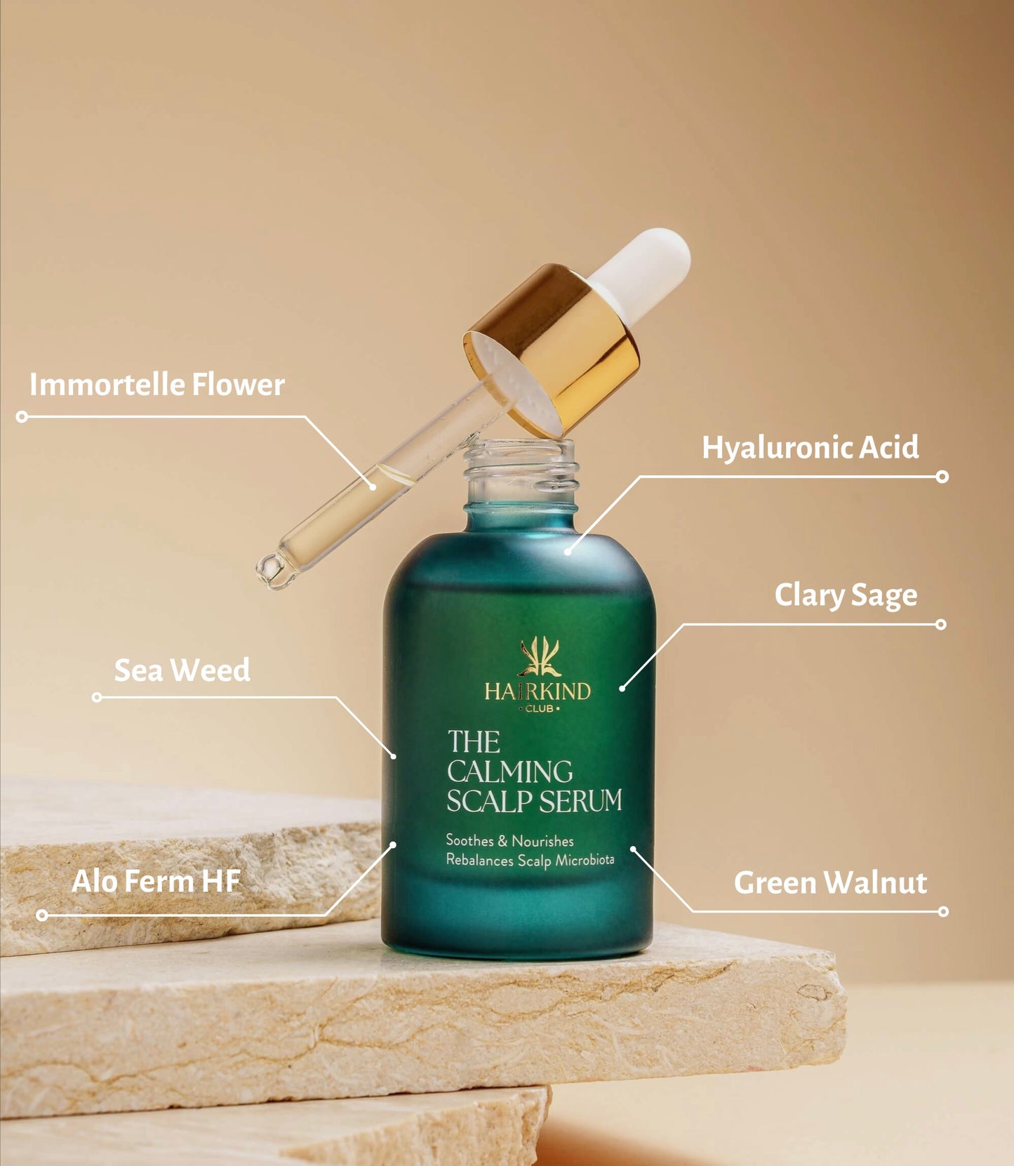 HairKind Club product bundle with serum and scalp comb on natural marble surface