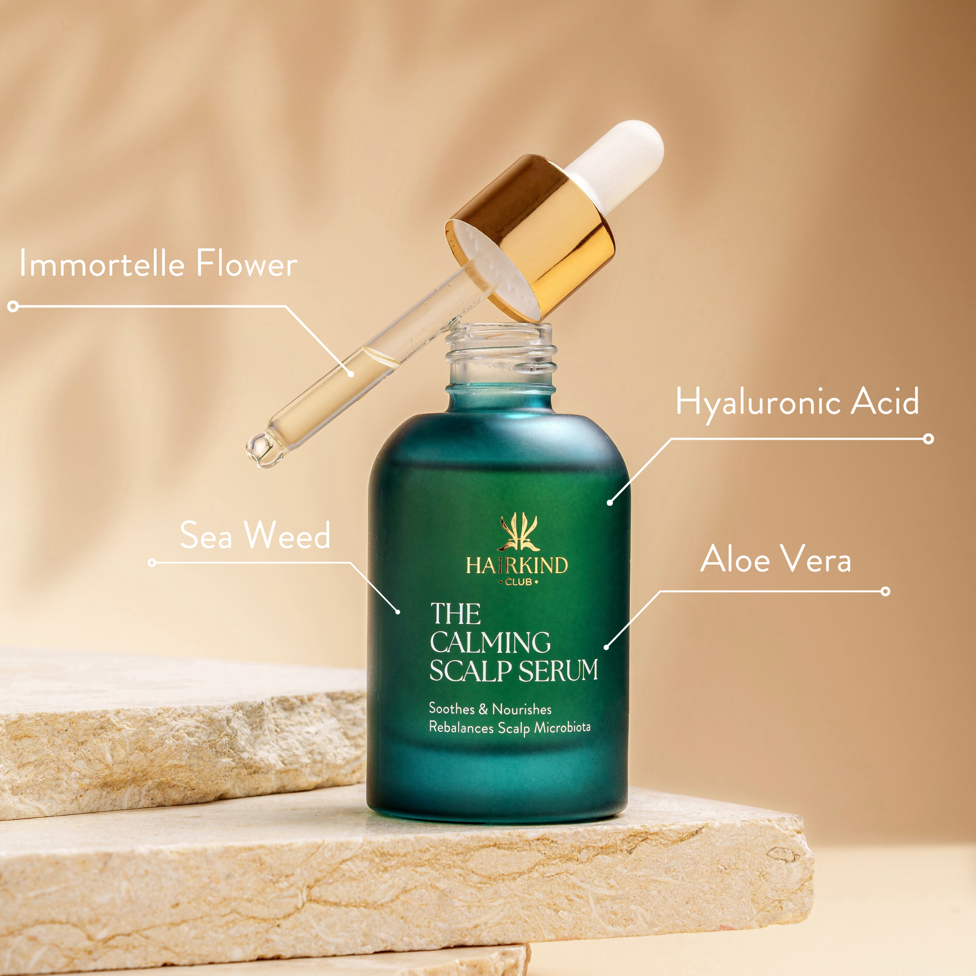 HairKind Club product bundle with serum and scalp comb on natural marble surface