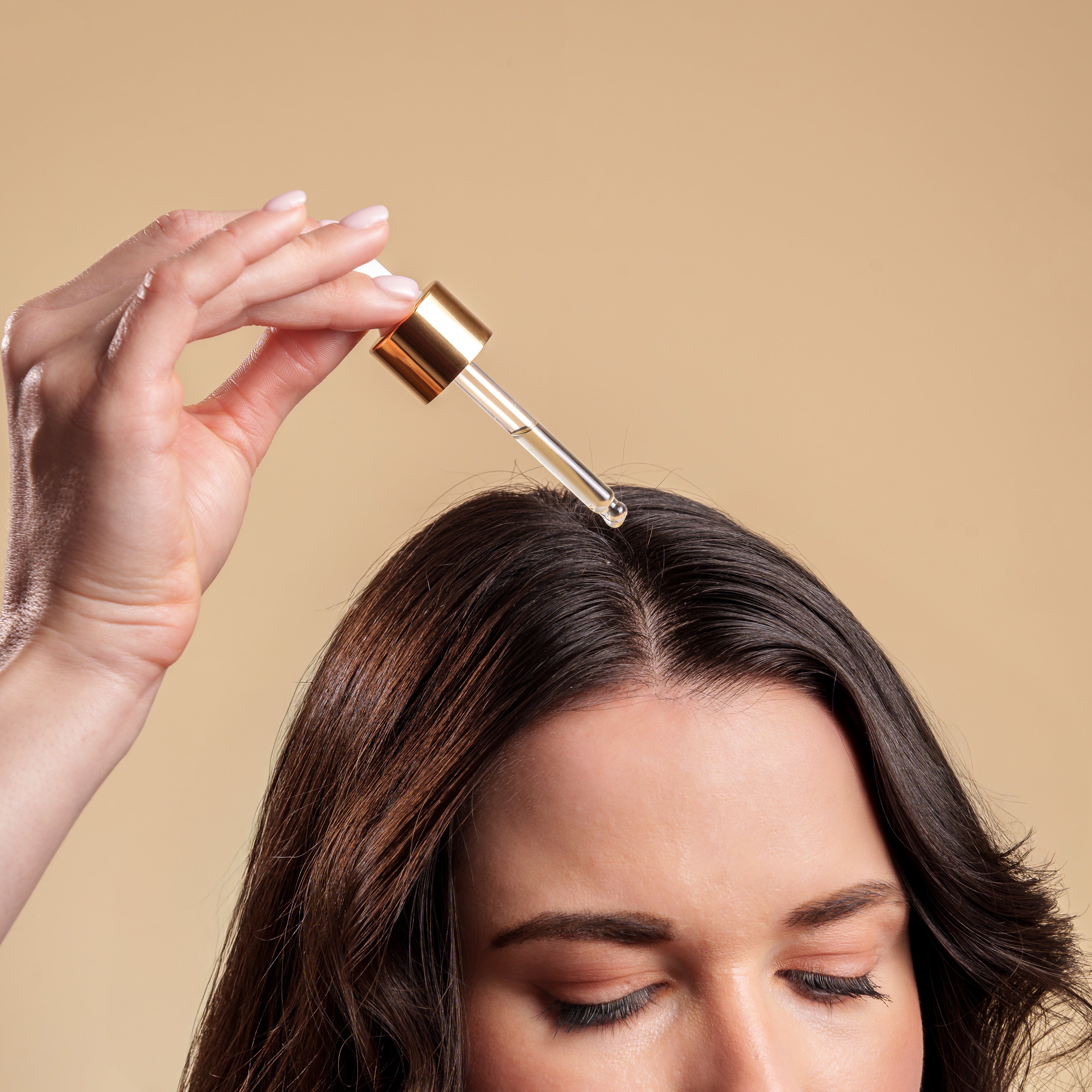Applying The Calming Scalp Serum directly to the scalp