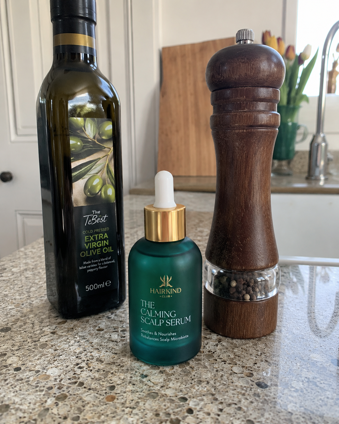 HairKind Calming Scalp Serum bottle on a kitchen counter